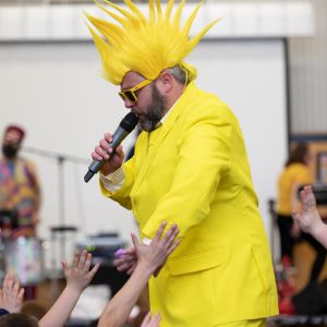 Jono Ruse dressed as the sun performing in a JAM Band show