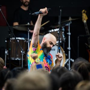 Nick Russell fist pumping in front of the audience during a JAM Band performance in Adelaide South Australia
