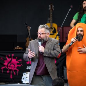 Jono Ruse in a suit and Nick Russell dressed as a carrot during a JAM Band performance in Adelaide South Australia
