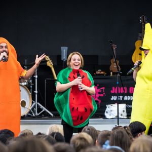 Nick Russell dressed as a carrot and Nina Verlingieri dressed as a watermelon and Eve Ormsby dressed as a banana for a JAM Band performance in Adelaide South Australia