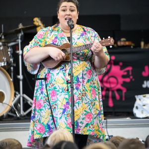 Eve Ormsby singing and playing ukulele for a JAM Band performance in Adelaide South Australia