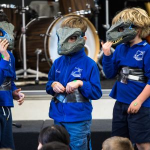 Students dressed up in dinosaur costumes at a JAM Band show in Adelaide South Australia