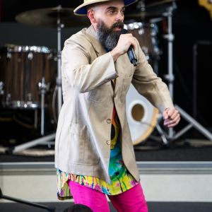 Nick Russell in a safari costume singing at a JAM Band performance in Adelaide South Australia